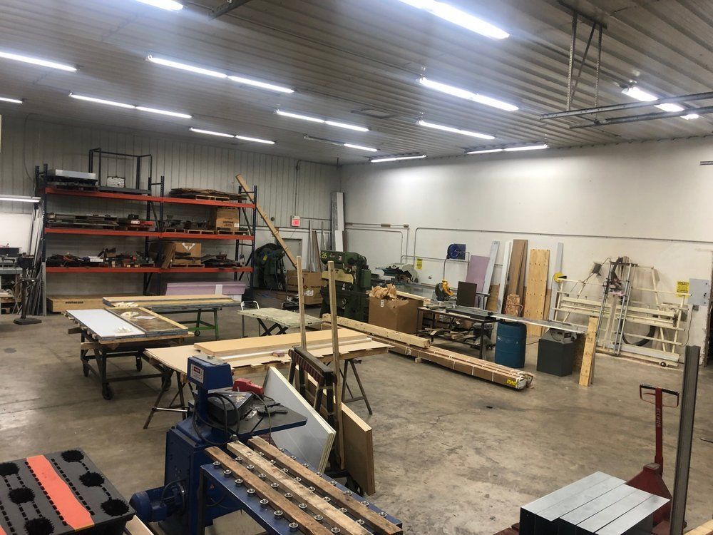 A large warehouse filled with lots of wood and machinery.