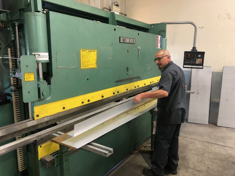 A man is working on a machine in a factory.