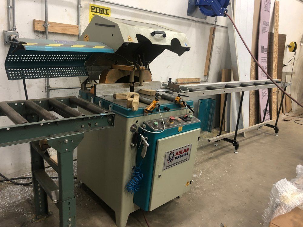 A machine is sitting in a room next to a ladder.