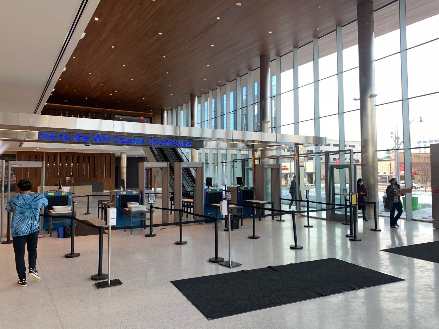 A large building with a lot of windows and people walking through it