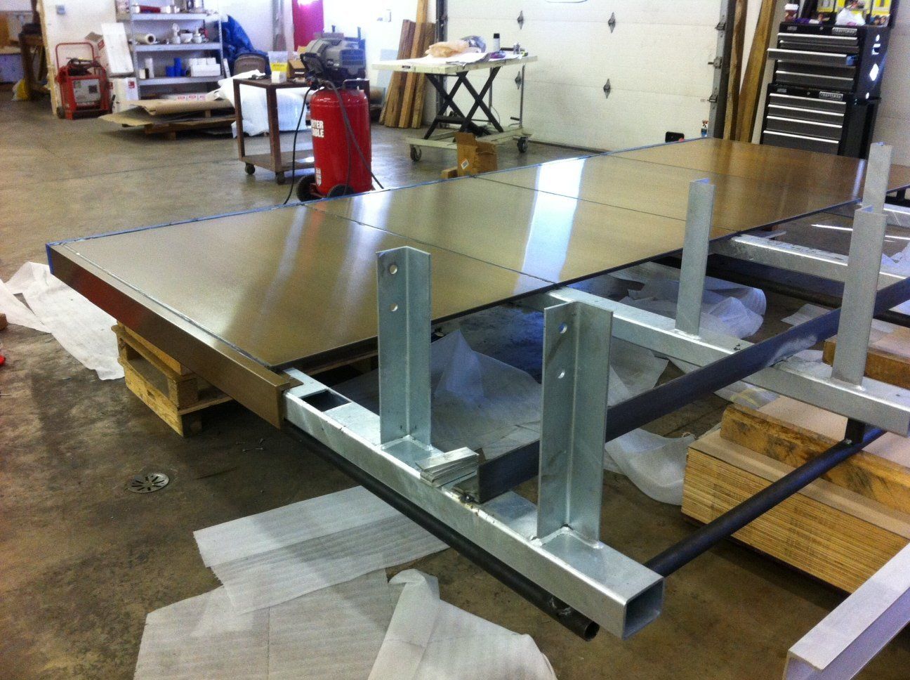 A large piece of metal is sitting on a table in a factory