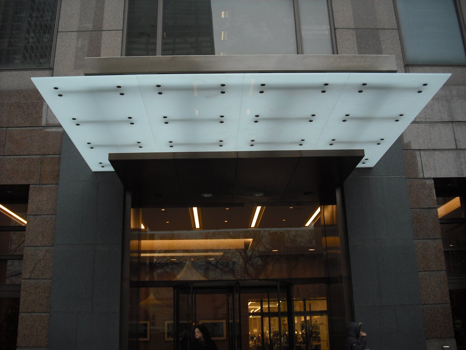 A building with a glass canopy over the entrance