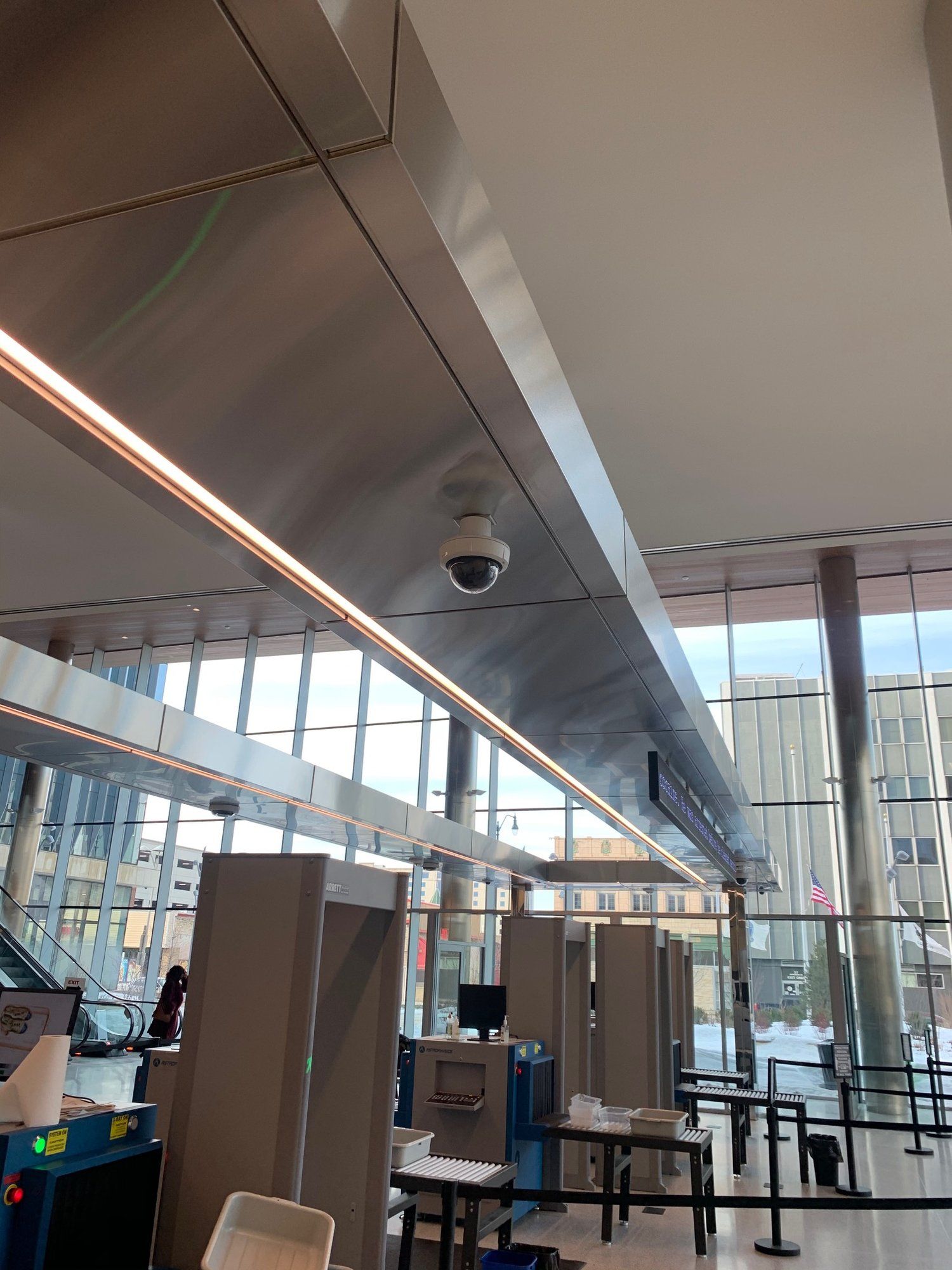 A camera is hanging from the ceiling of a building