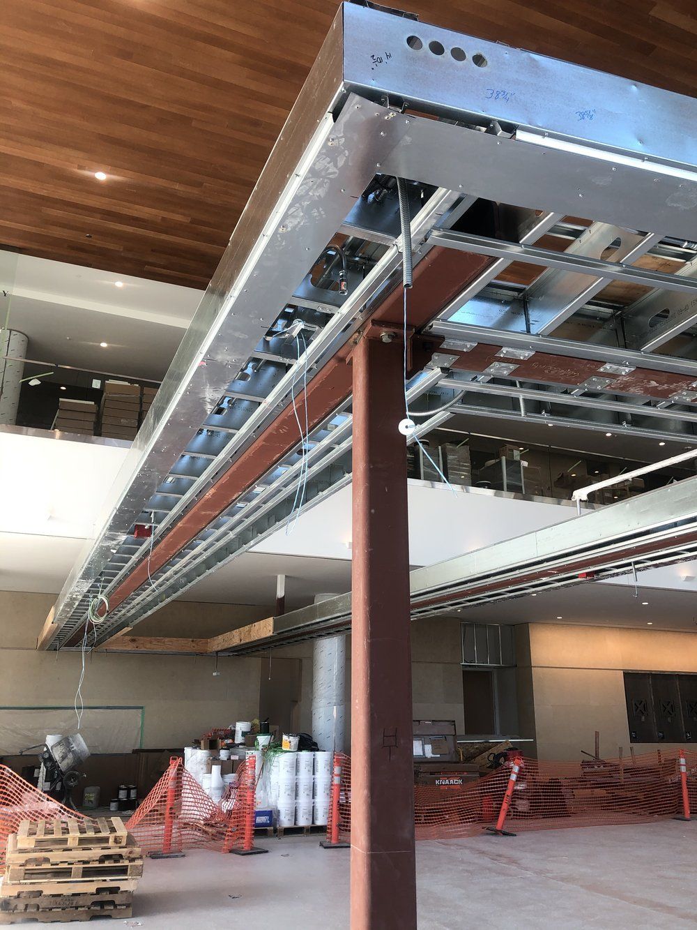 A large room with a ceiling that is being built.