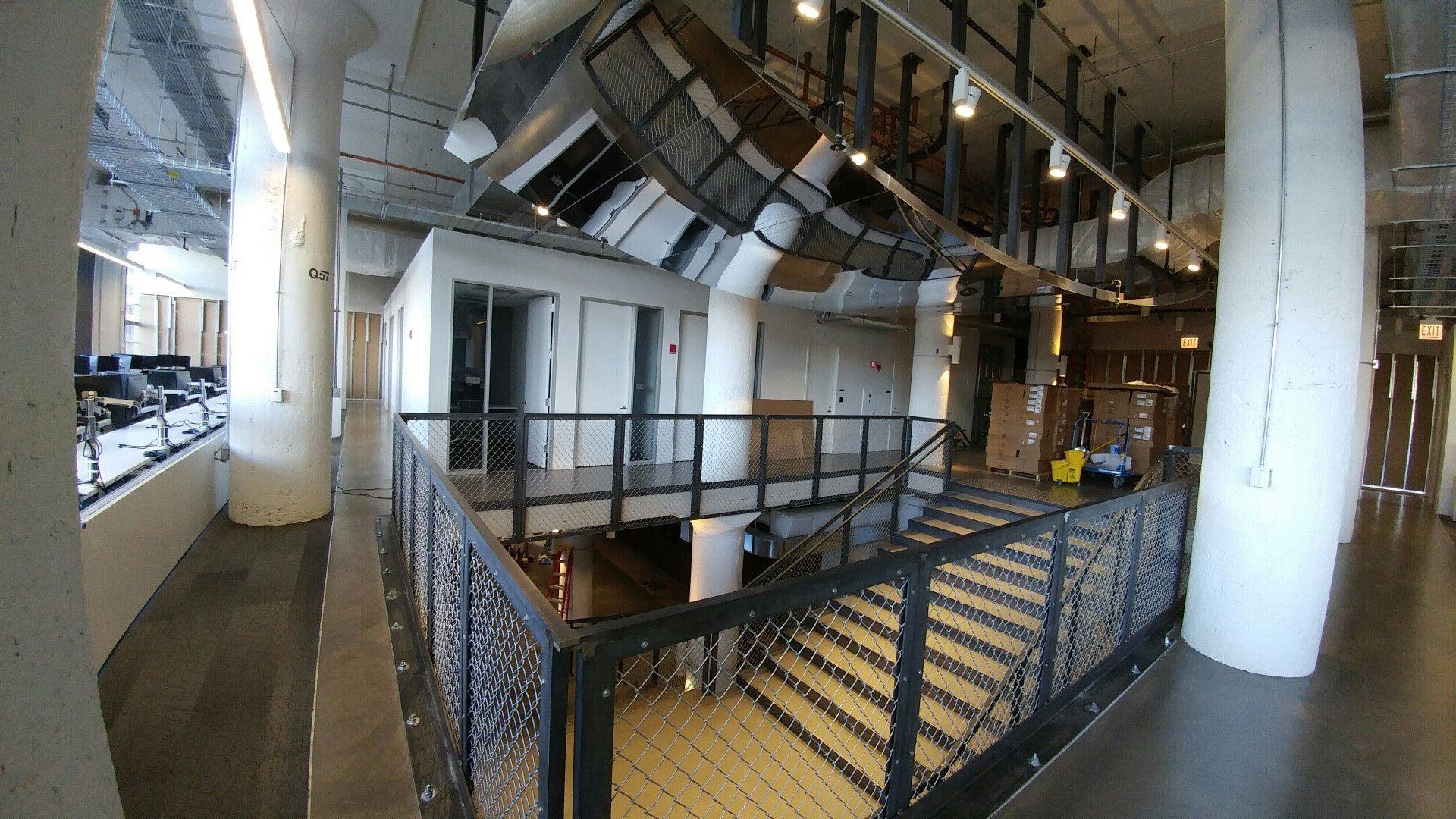 A large building with stairs leading up to the second floor