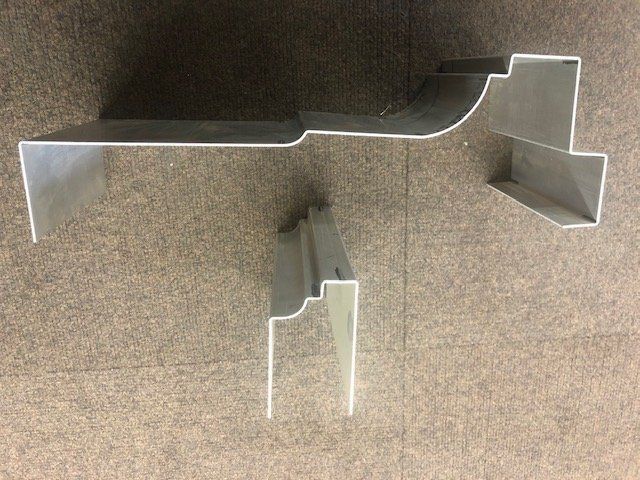 A piece of metal is sitting on top of a carpeted floor.