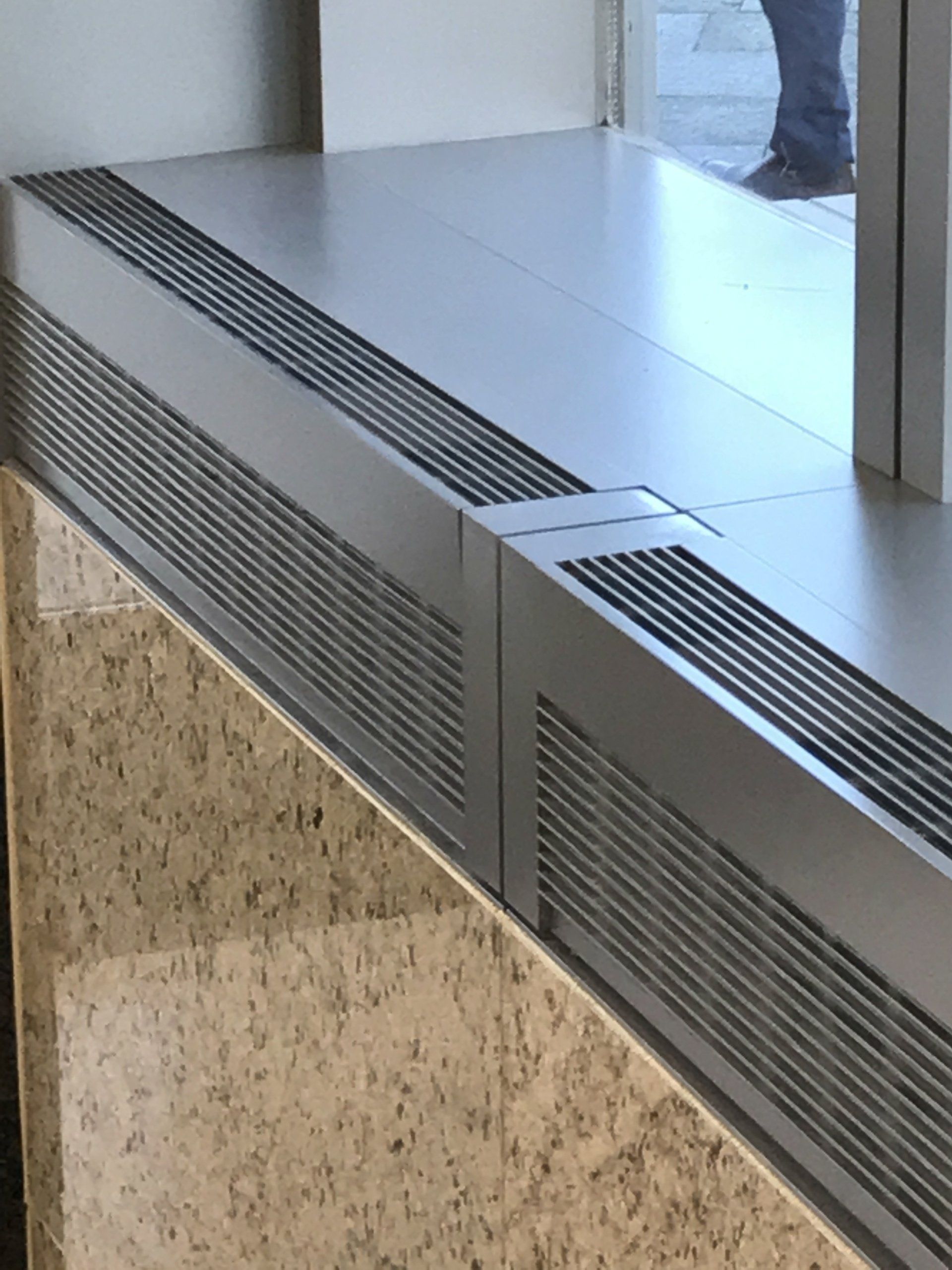 A person standing in front of a window with a reflection