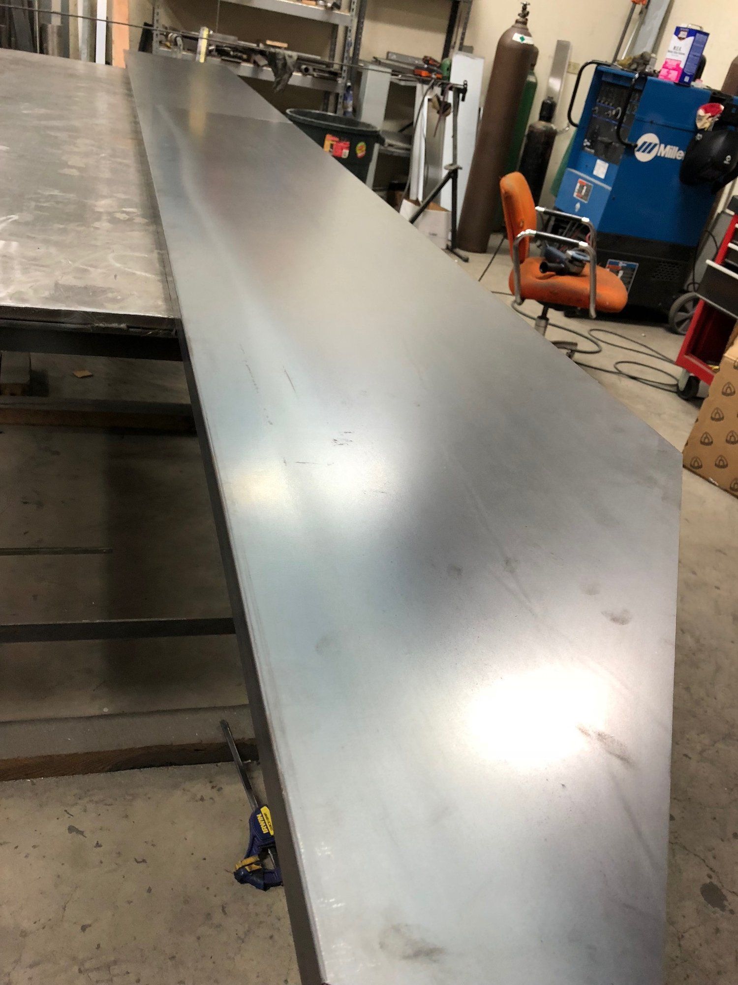 A large piece of metal is sitting on top of a table in a workshop.