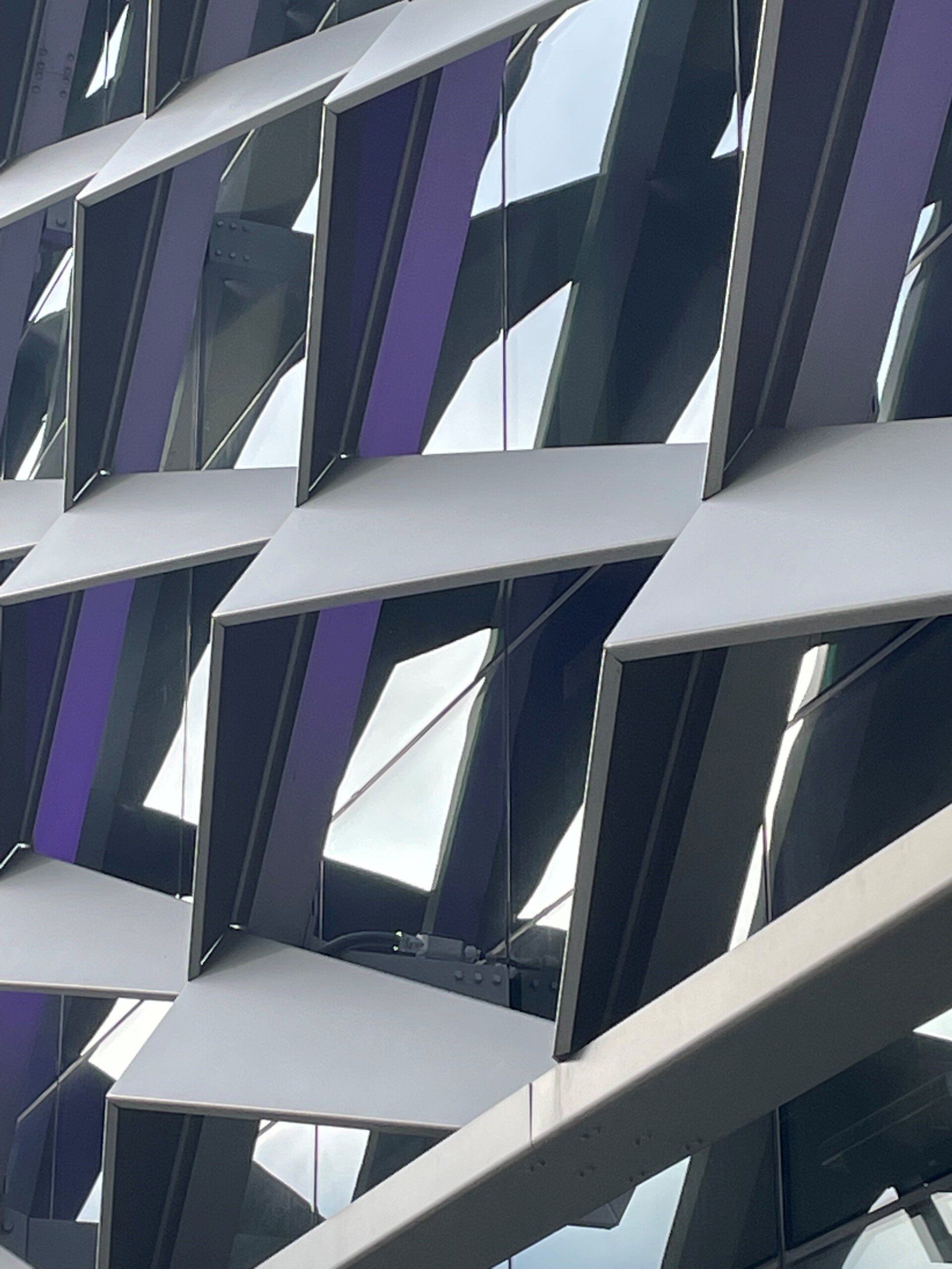 A close up of a building with purple windows