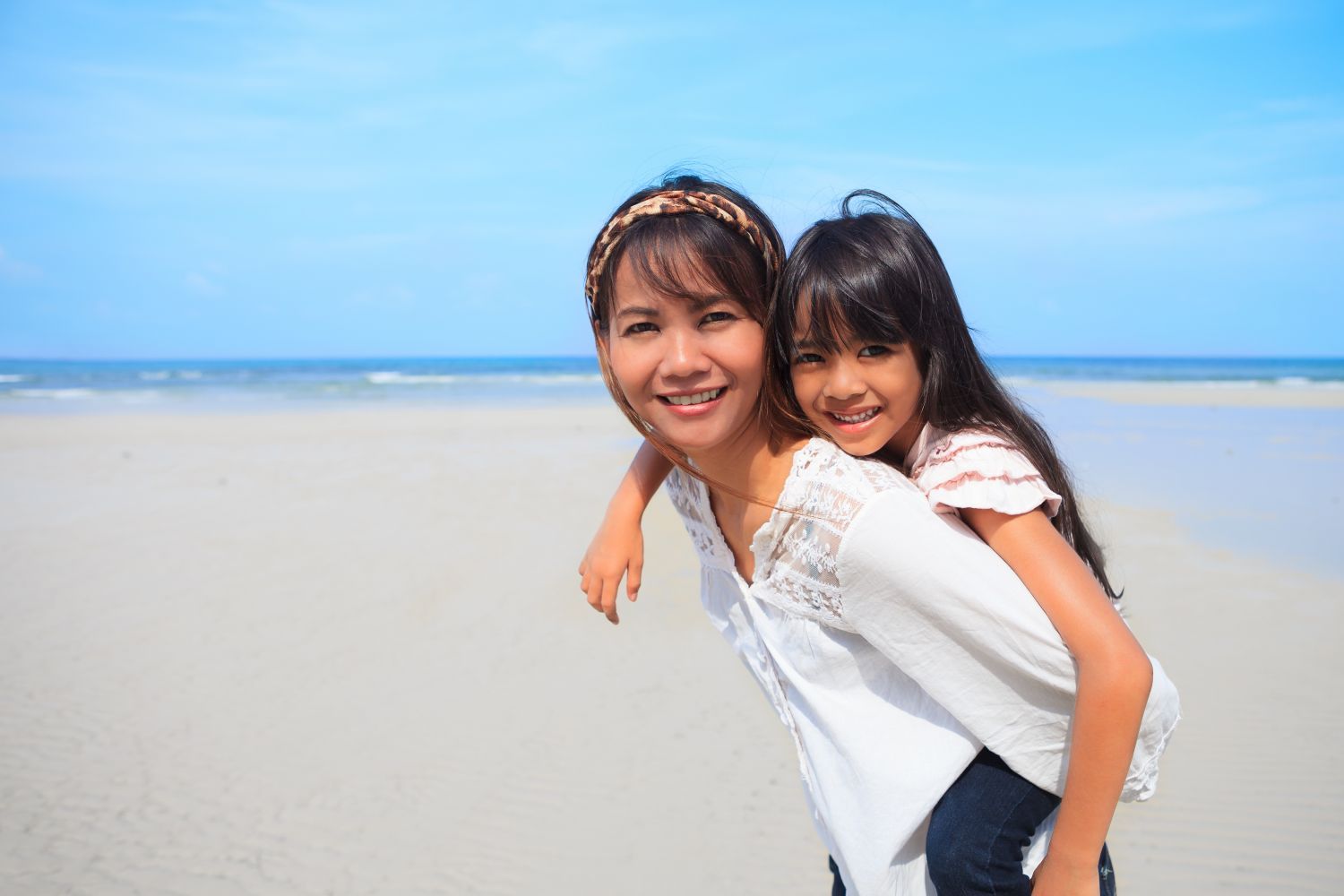 Dentist and assistant with young child, we specialize in family dentistry in Kailua, HI
