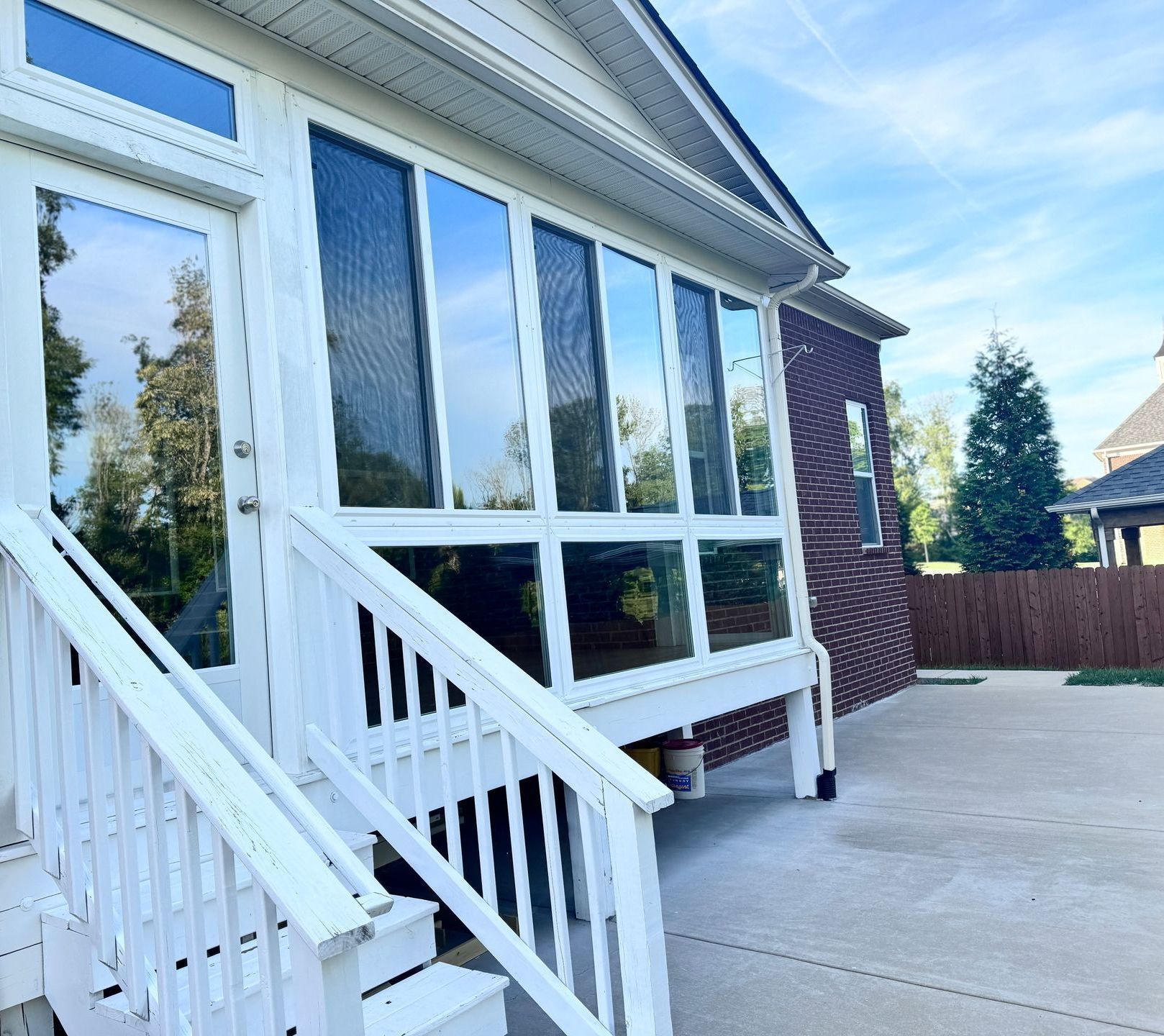 A house with a lot of windows on the side of it.