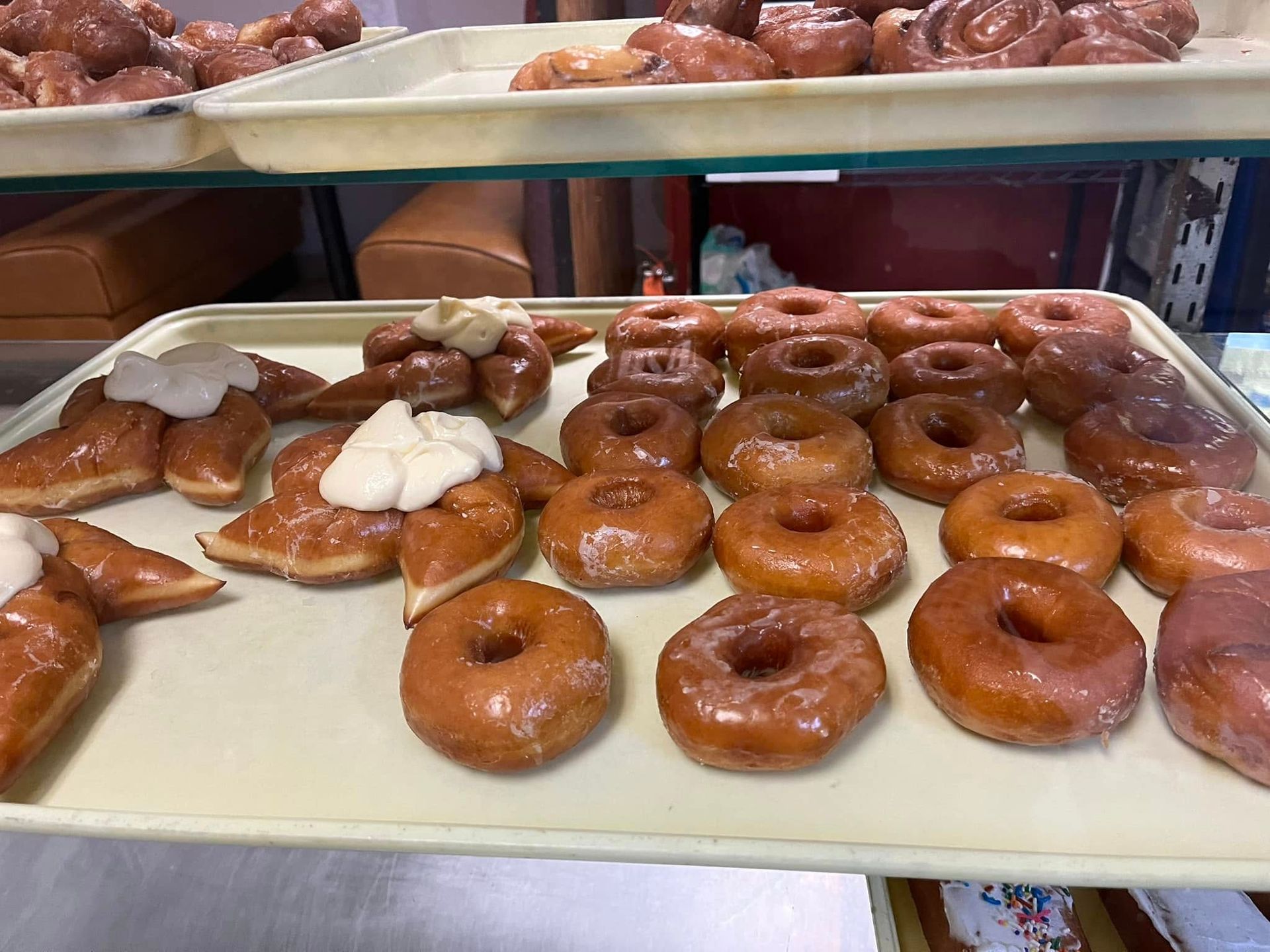 There are many different types of donuts on a tray.