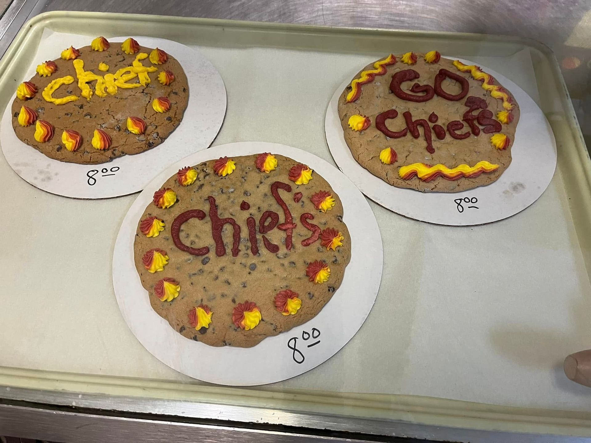 Three cookies on a tray that say go chiefs