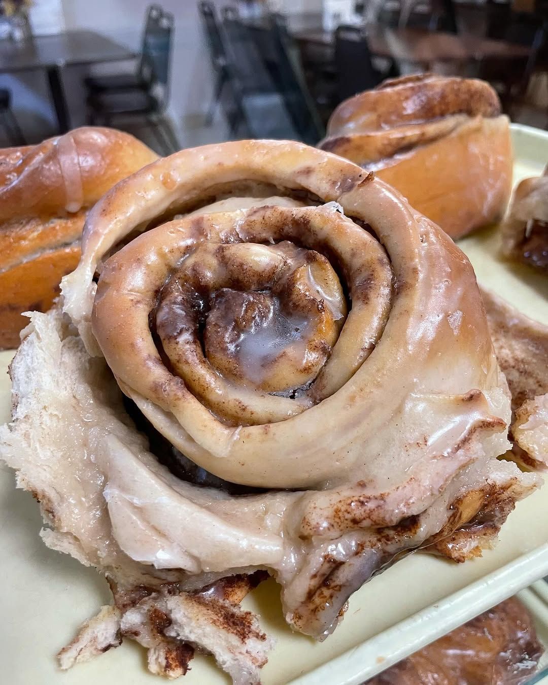 A close up of a cinnamon roll on a plate.