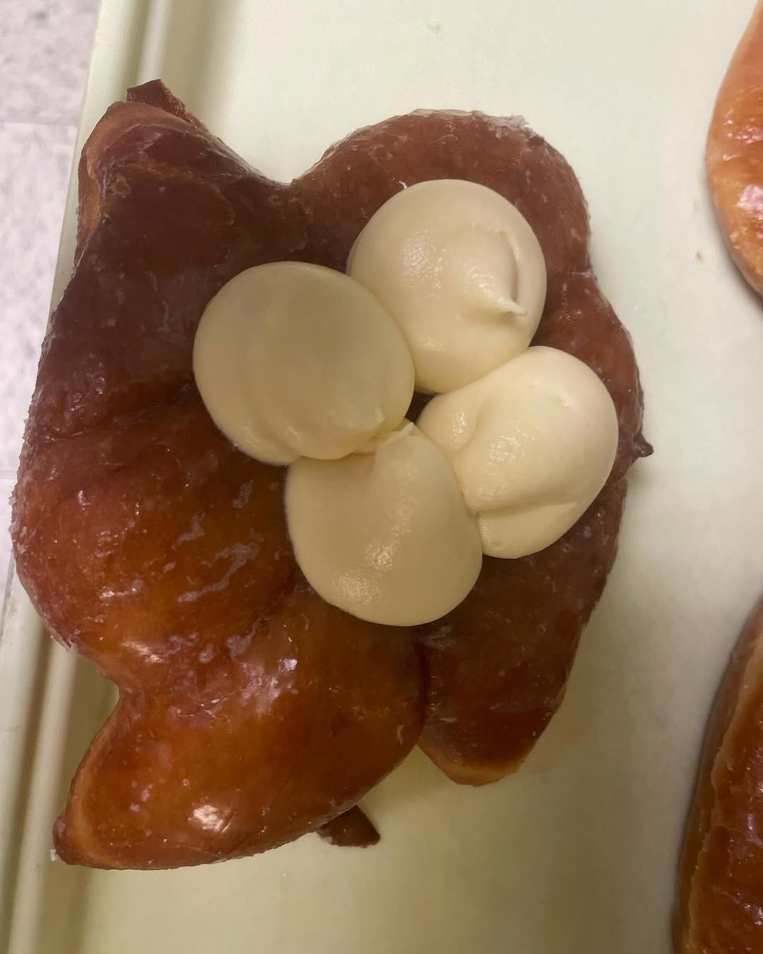 A close up of a donut with frosting on it