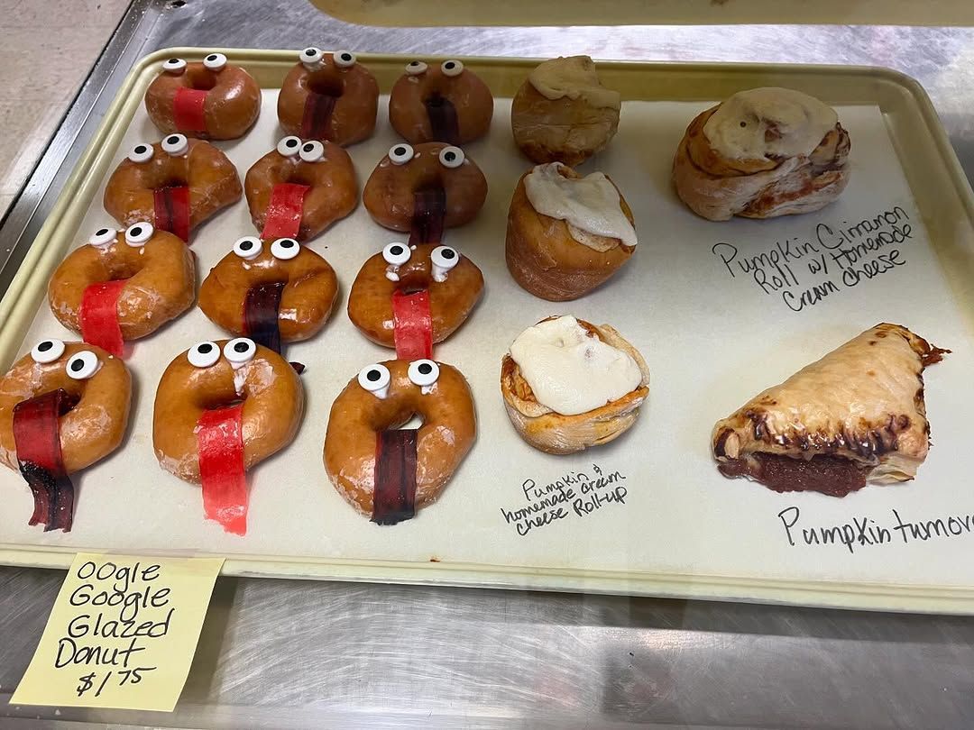 A tray of donuts and pastries including a pumpkin pie