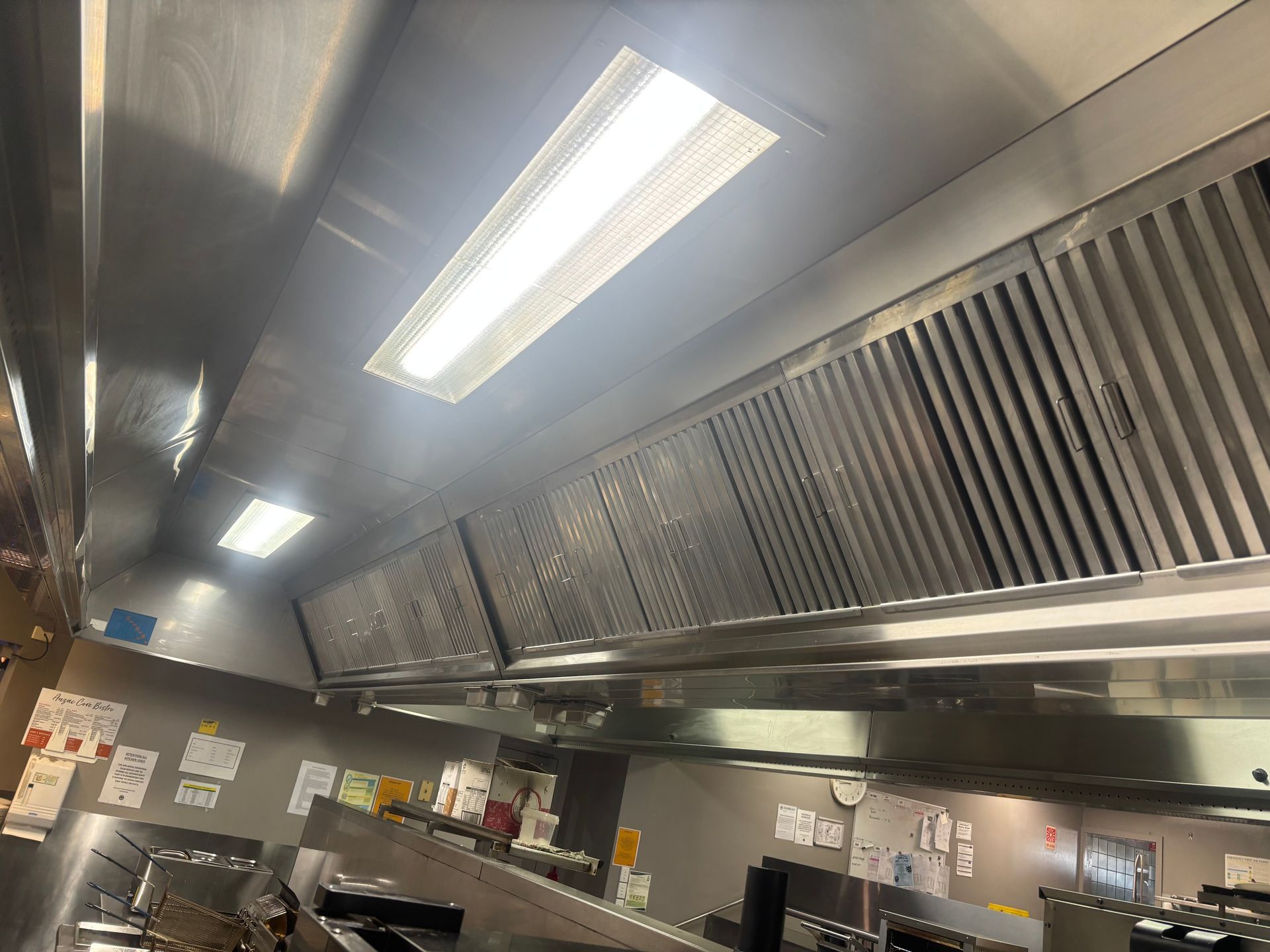 A large commercial kitchen with lots of stainless steel appliances  — DM & MM Services Pty Ltd in Ayr, QLD