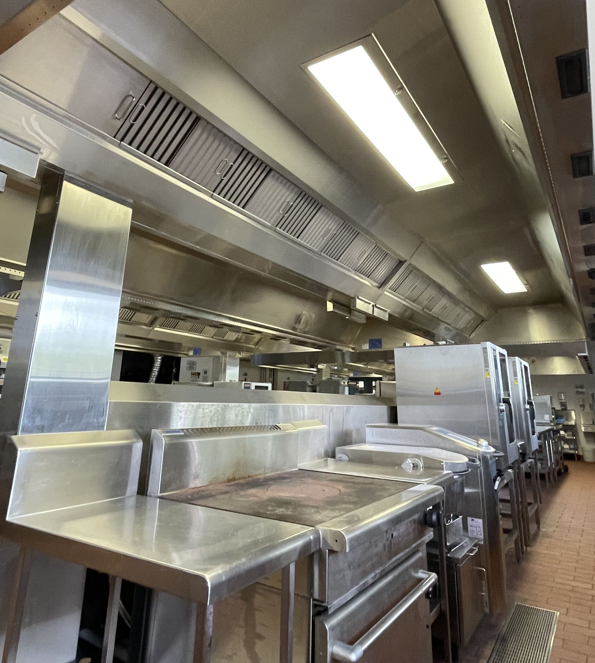 A Stainless Steel Oven Is Sitting In A Kitchen Next To A Stack Of Pizza Boxes — DM & MM Services Pty Ltd in Ayr, QLD