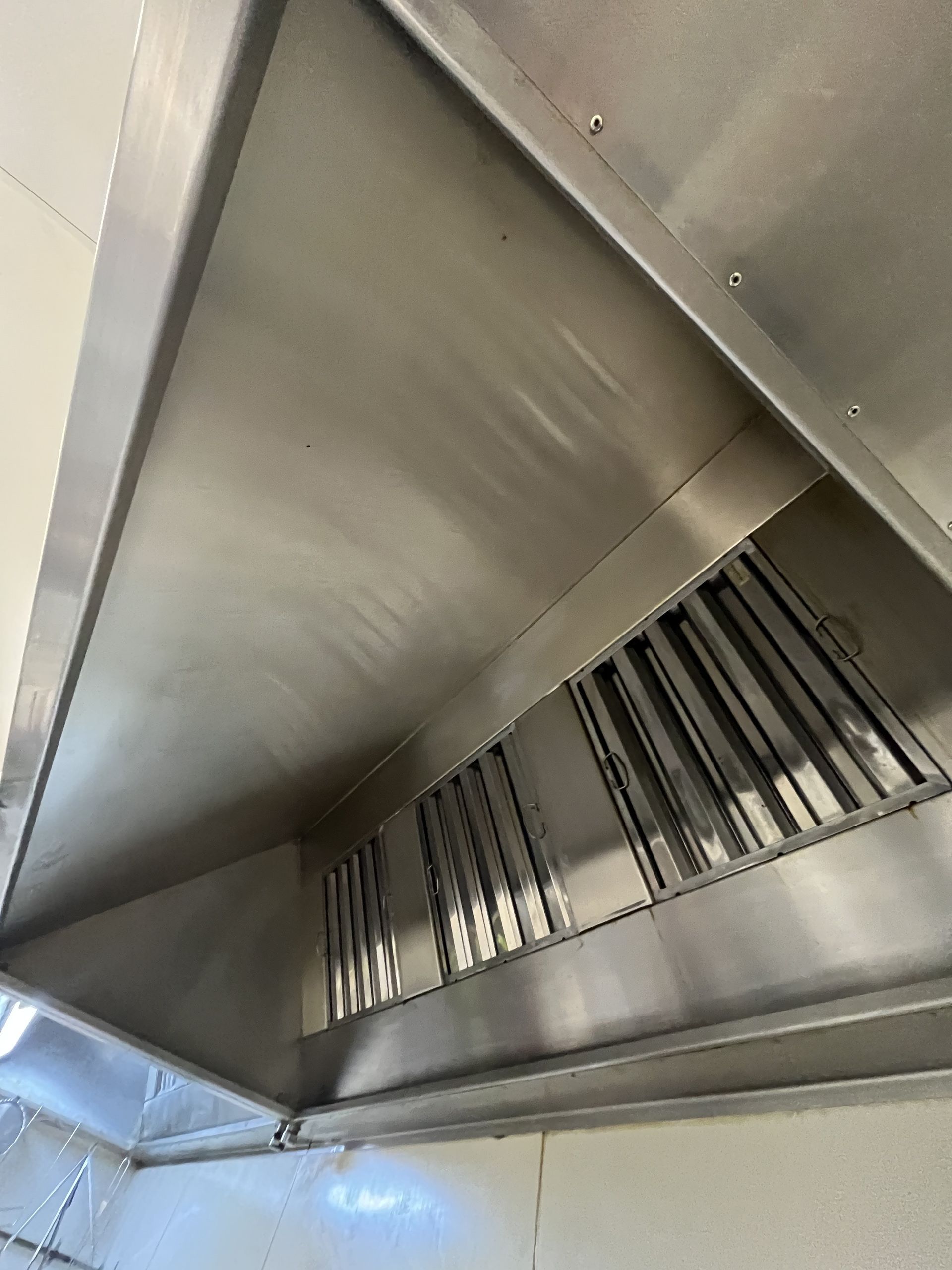Stainless steel commercial kitchen hood with grease filters. - DM & MM Services, Exhaust Cleaning, Townsville, QLD.