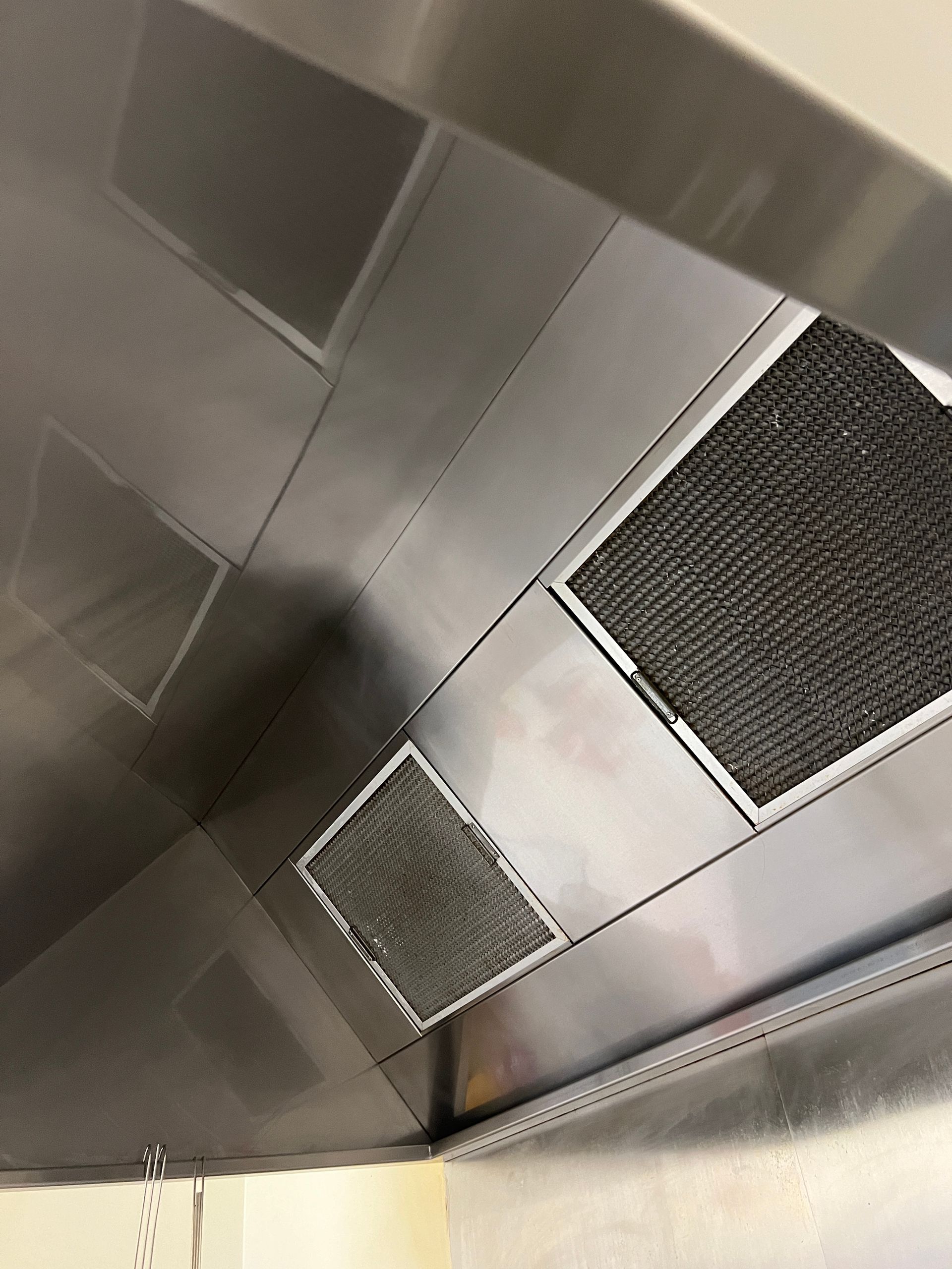 A Stainless Steel Wall With a Grid of Circles on It — DM & MM Services Pty Ltd in Charters Towers, QLD