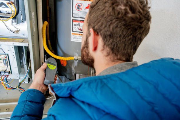 A technician fixing a furnace unit. — North Royalton, OH — Len's Heating & Air Conditioning