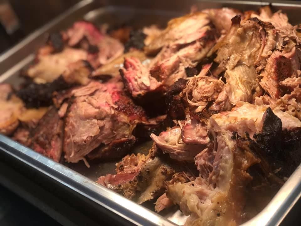 A tray of meat is sitting on a table.