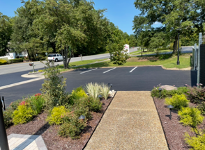 Road paving crew laying asphalt on a highway. Men in safety vests and hard hats work with equipment.