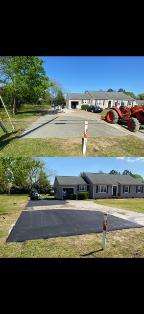 Road rollers compacting fresh asphalt on a sunny day.