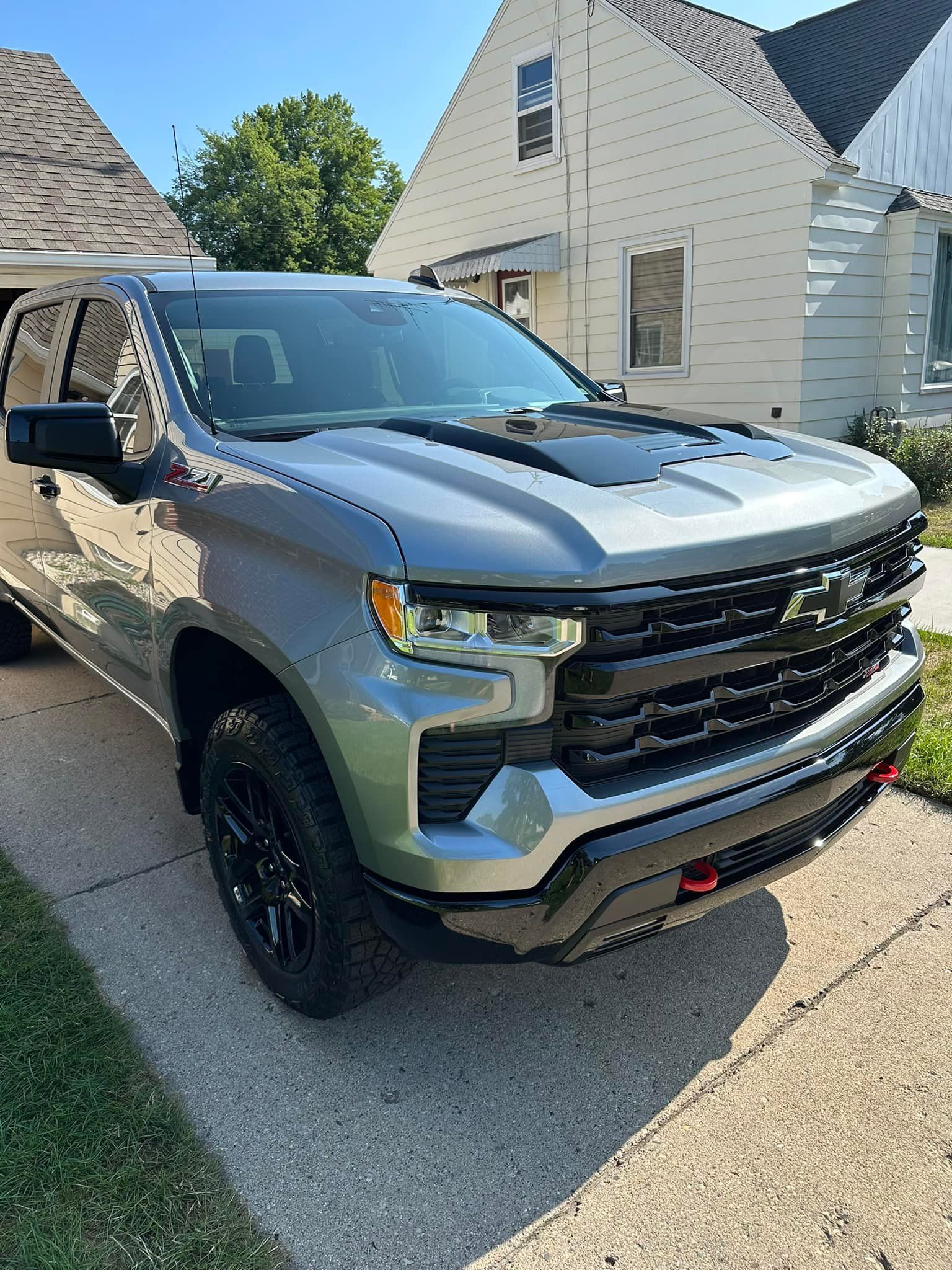 Gray Chevrolet Silverado truck parked in front of a house.