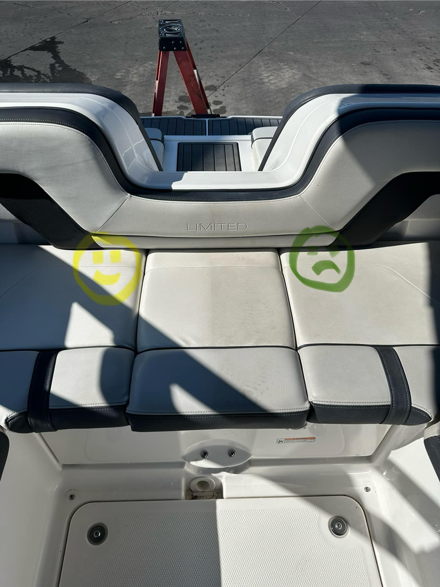 Boat interior with white and gray seats, marked with yellow and green circles.
