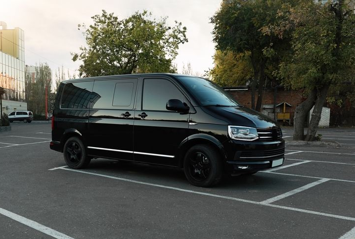 Black Volkswagen van parked in a parking lot.