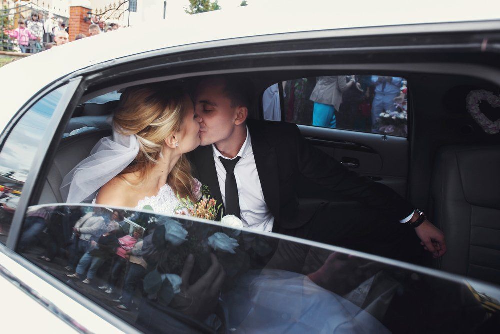 Happy Romantic Newlyweds Kissing in Wedding Limo — Transport in Newcastle
