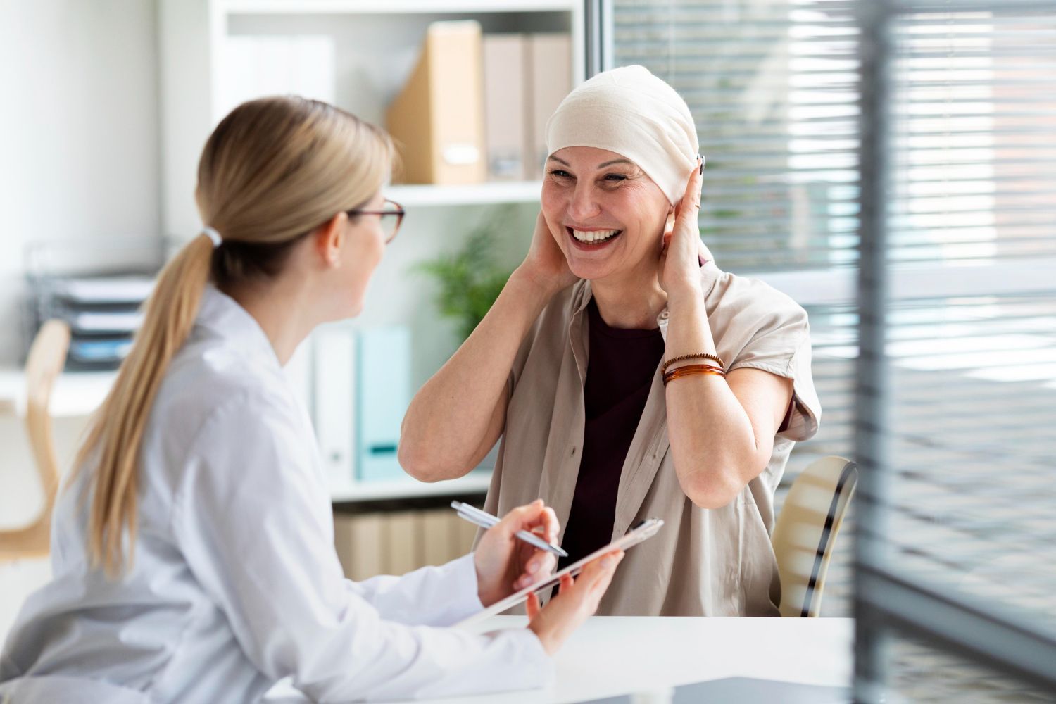 A woman with a bandage on her head is talking to a doctor.