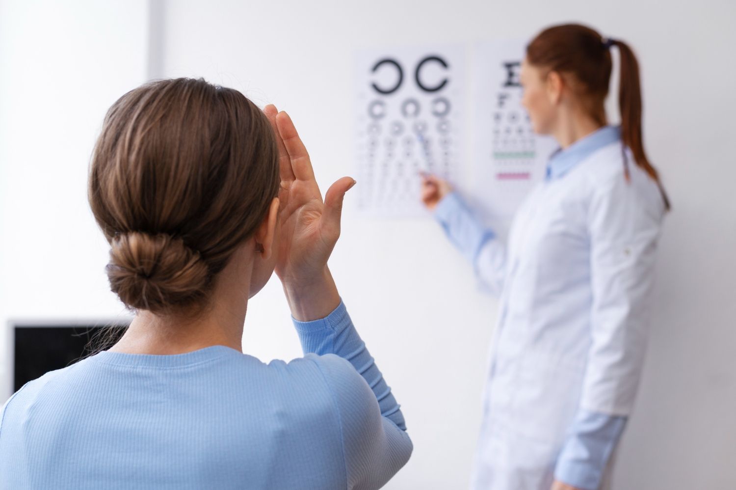 A woman is having her eyes examined by an ophthalmologist.