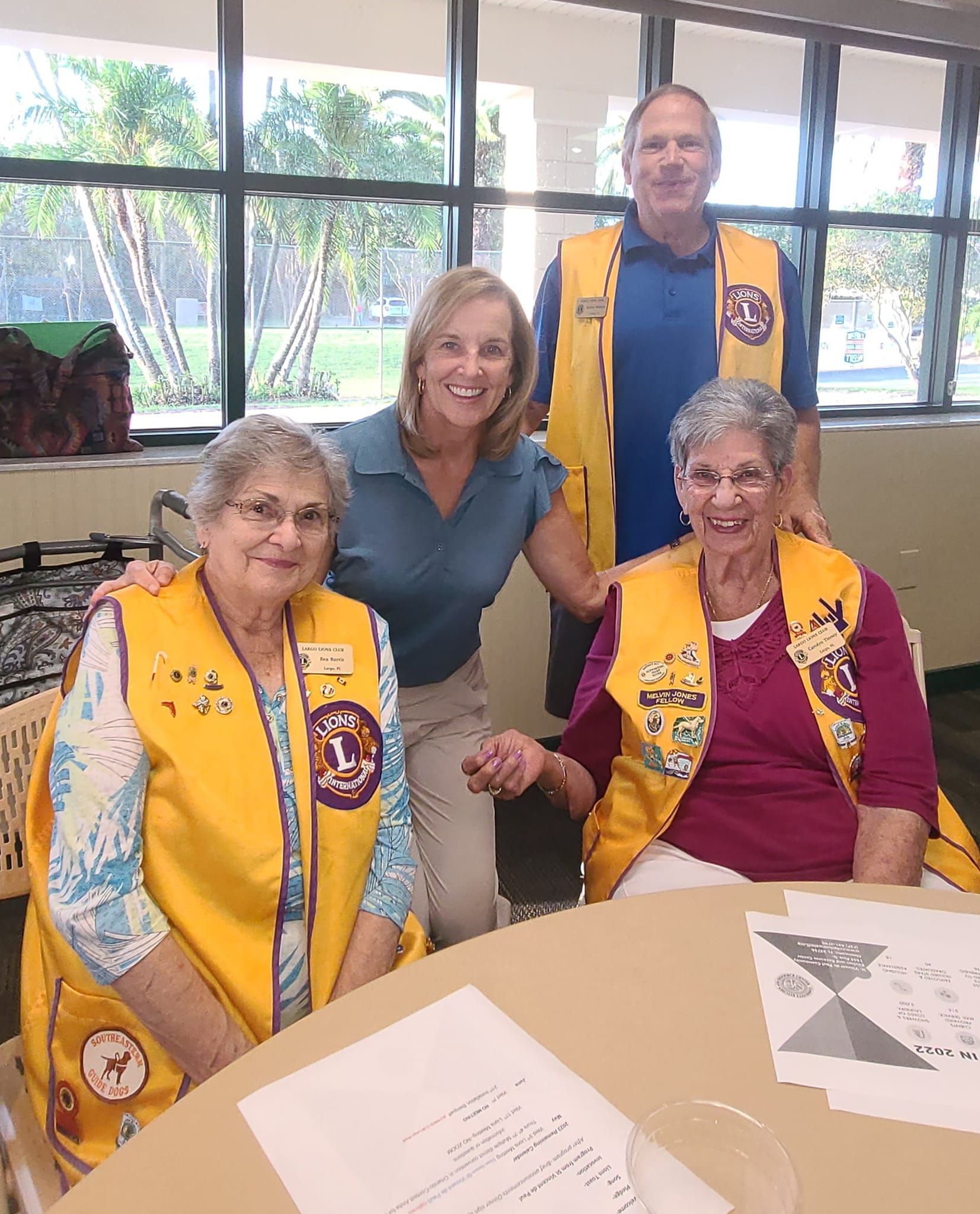 A group of people wearing yellow vests are posing for a picture.
