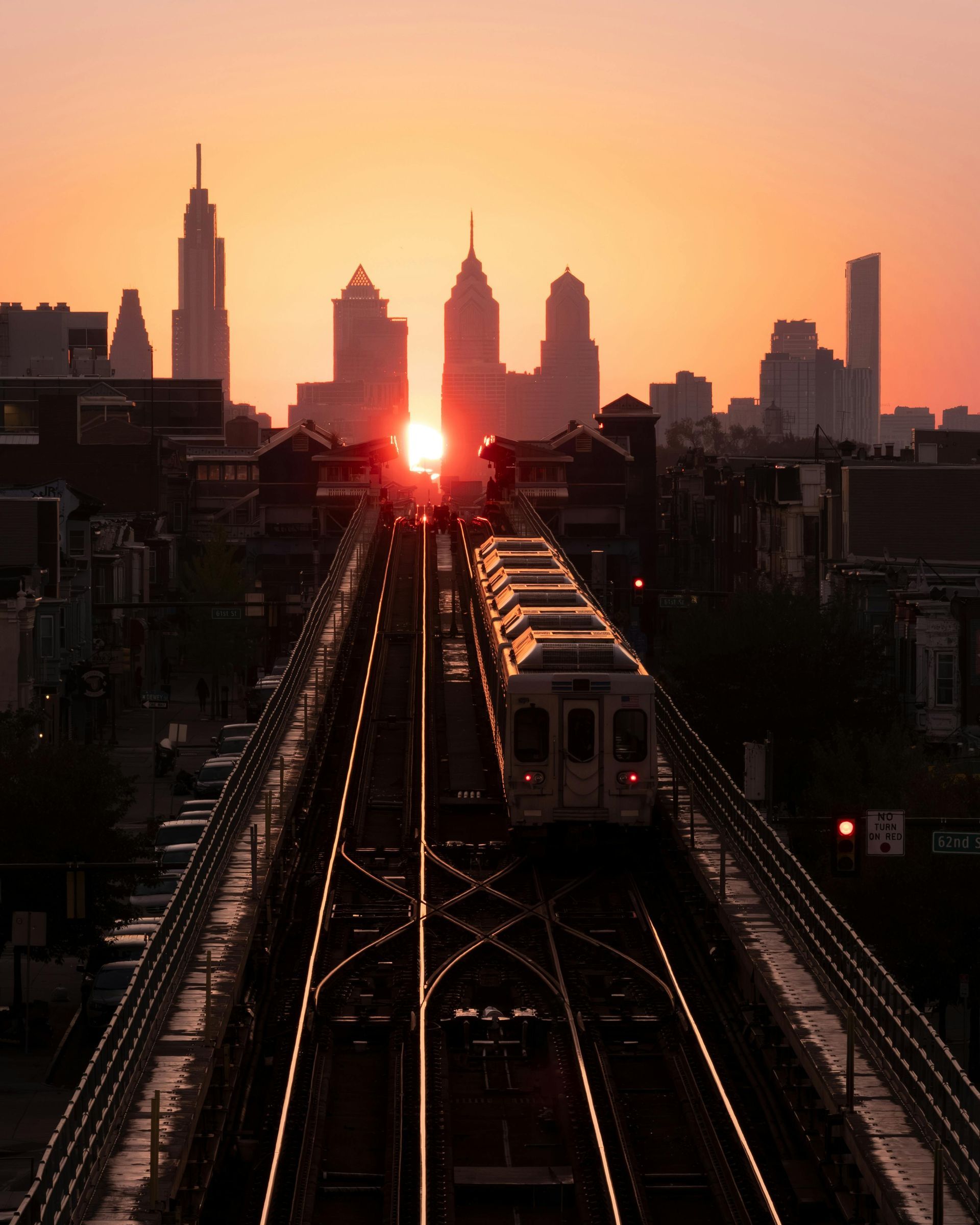 A train is going down the tracks at sunset