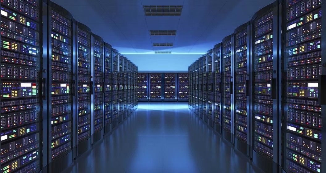 Rows of servers in a data center, illuminated by blue light.