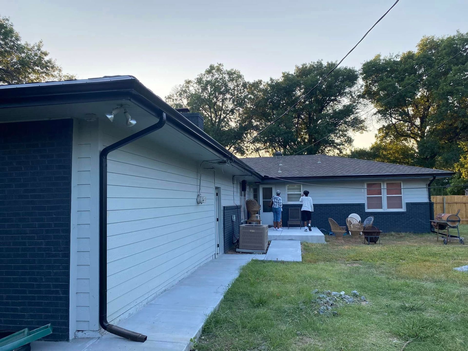 A man is painting the side of a house.
