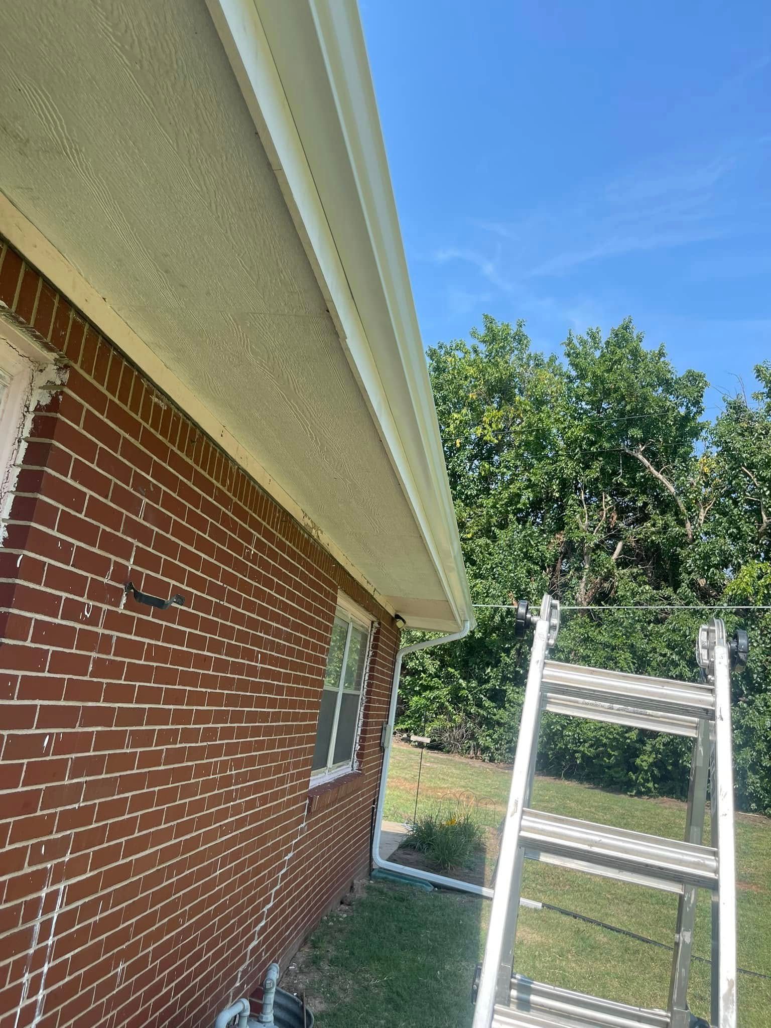 A ladder is sitting on the side of a brick house.