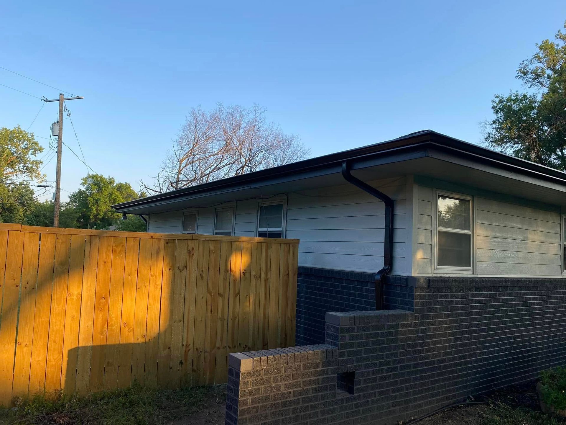 A house with a wooden fence in front of it