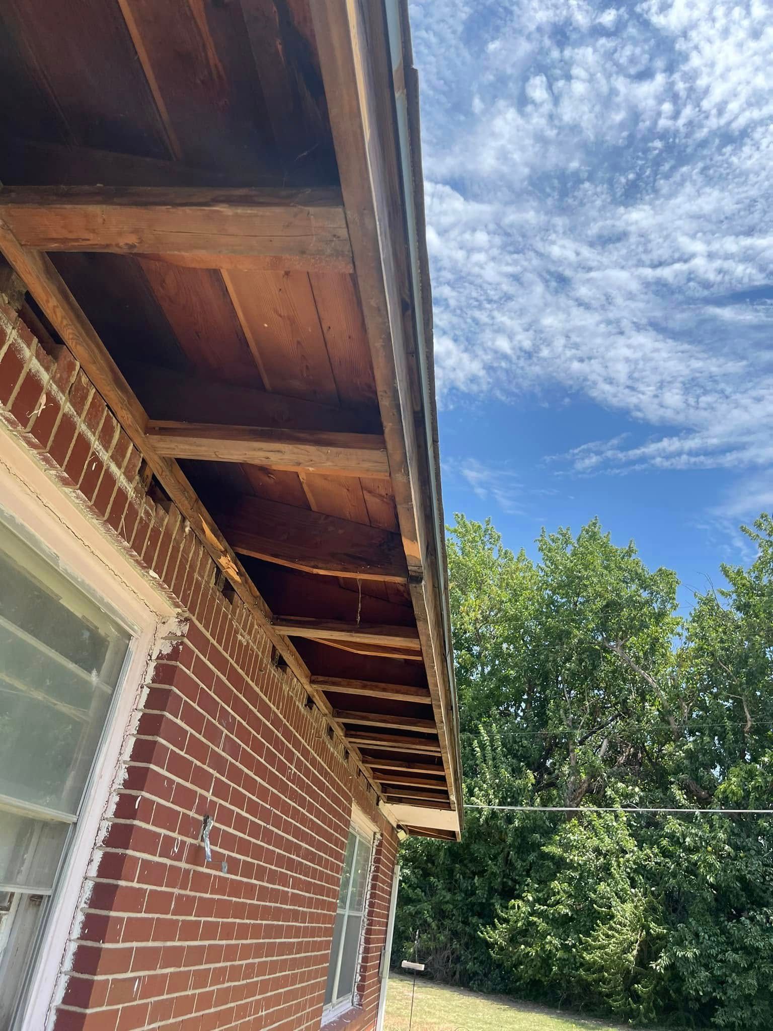 A brick house with a wooden roof and a balcony.