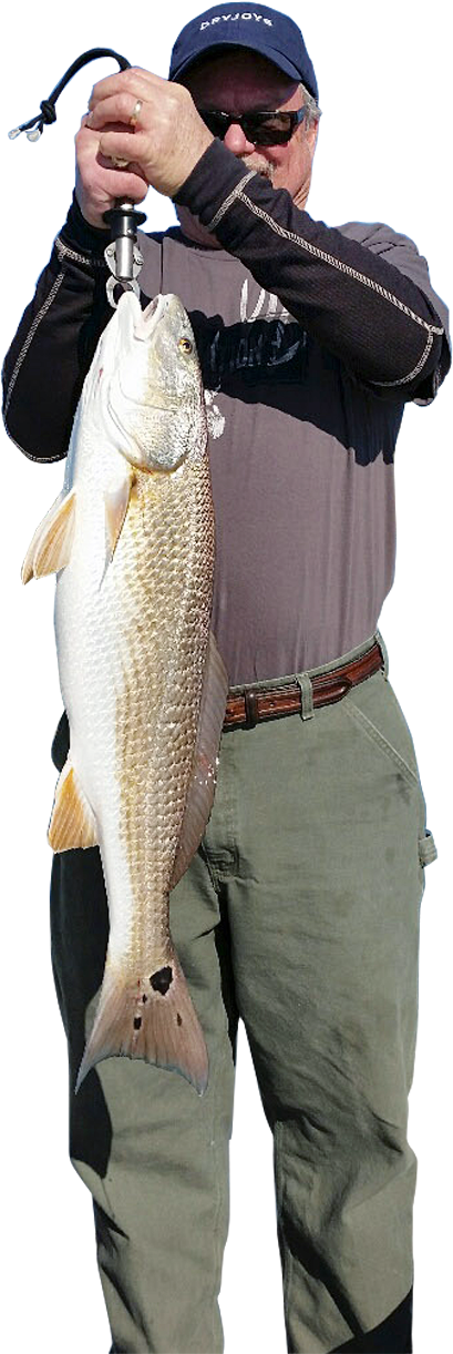 A man is holding a large fish in his hands.