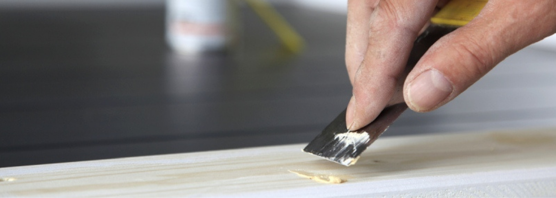 Picture of someone applying wood filler.