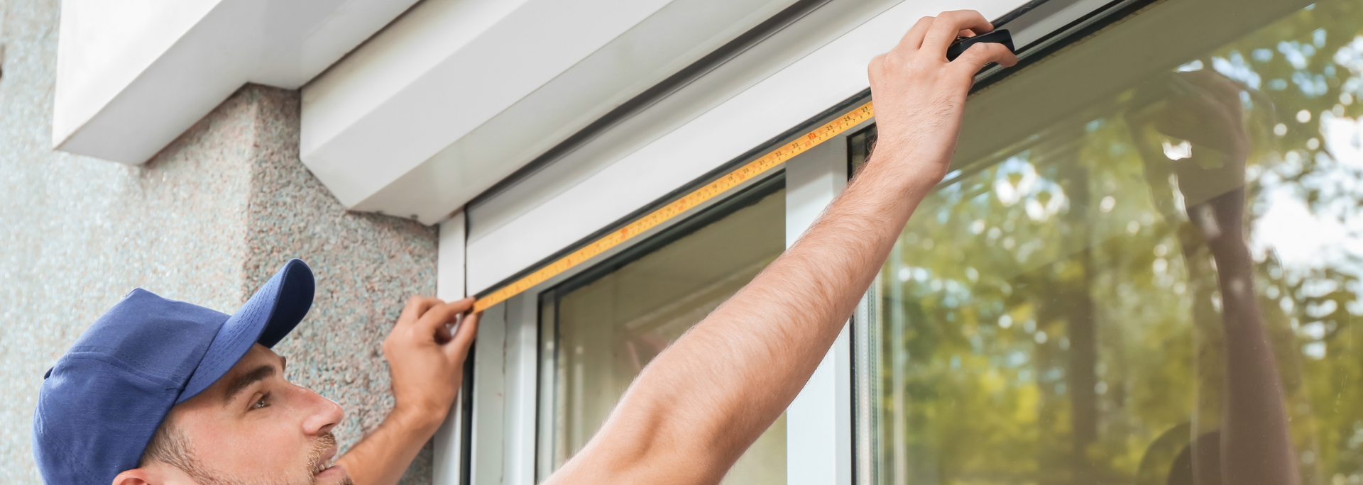 Picture of someone measuring the width of a window.