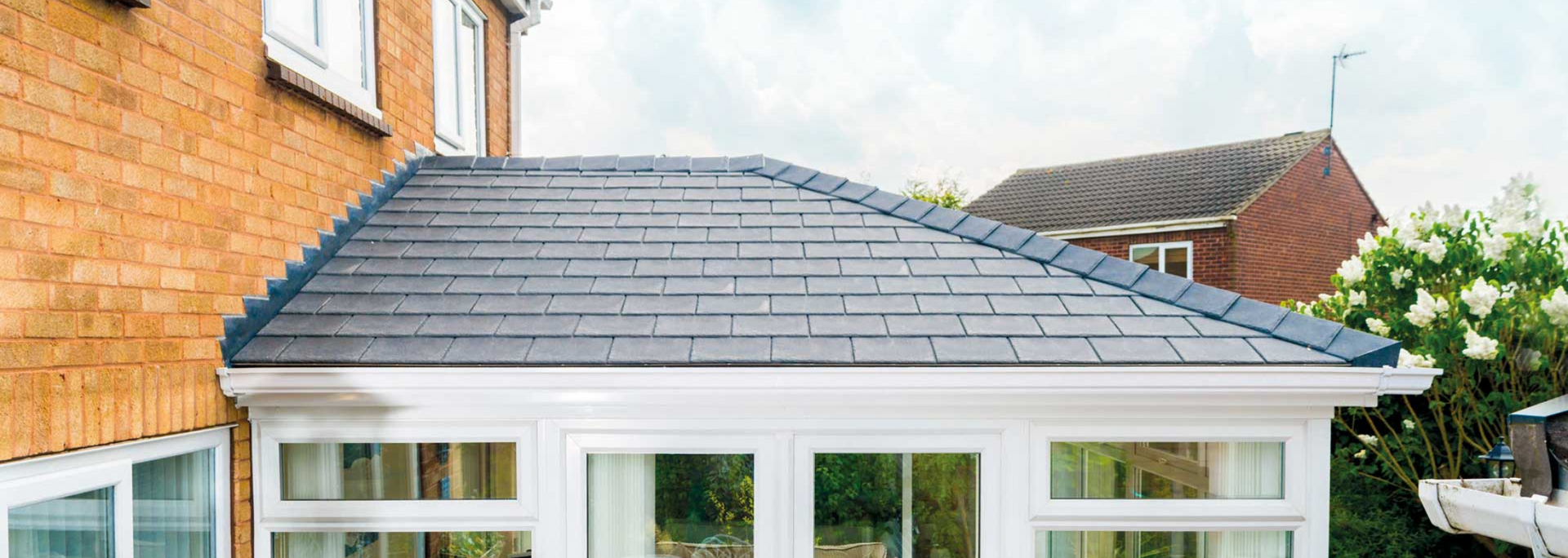 Picture of a conservatory with a tiled roof.