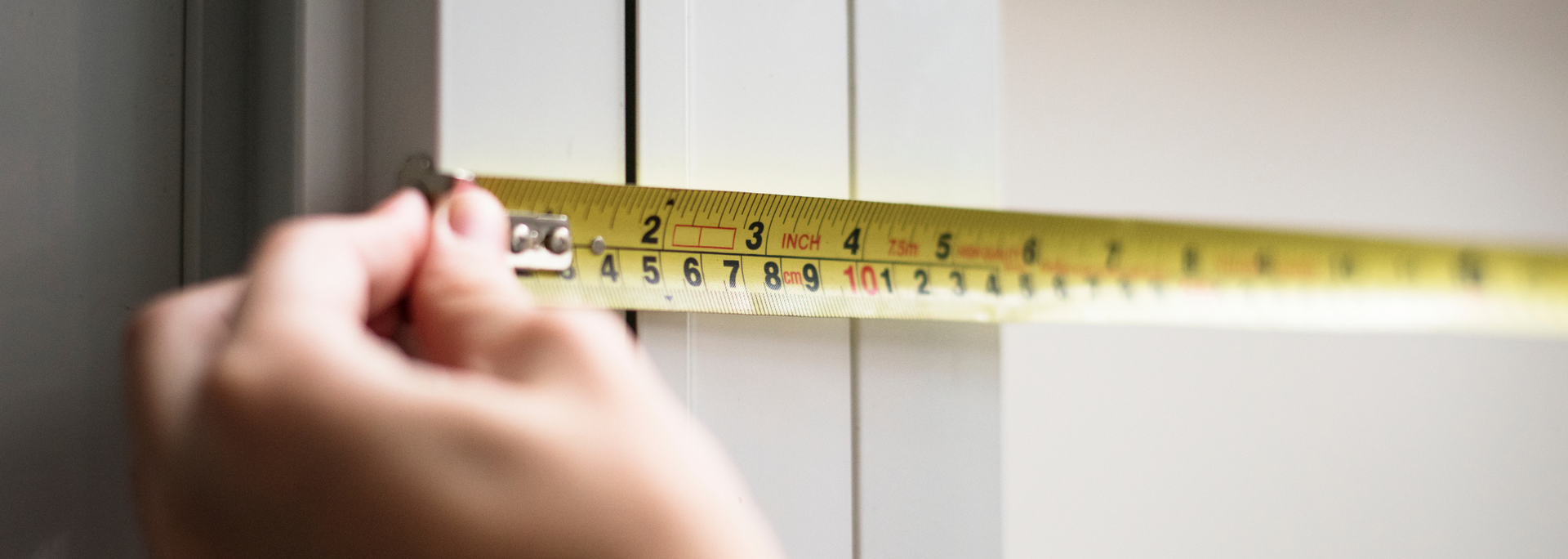 Picture of a person measuring a door. Picture of a person measuring a door.