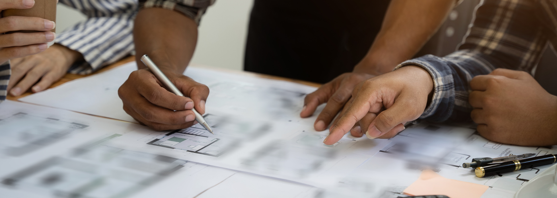 Professionals looking at building designs. Professionals looking at building designs.