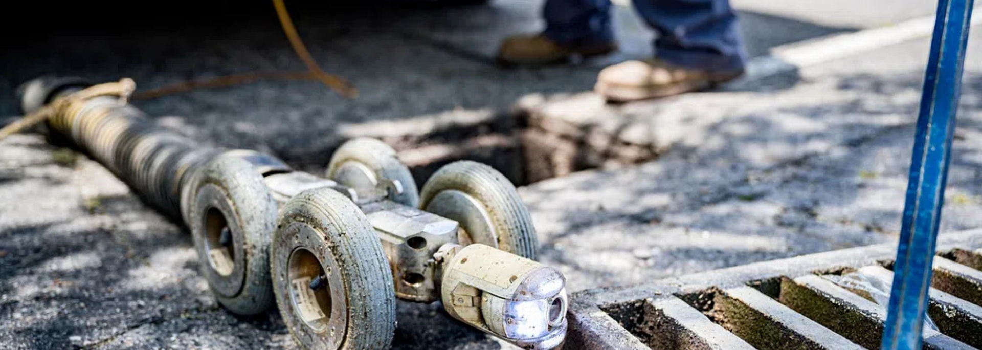 Picture of water technicians working on a drain.