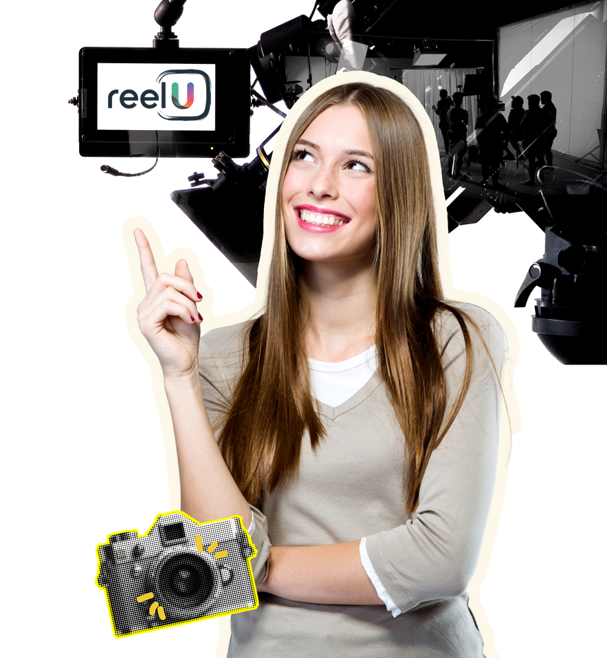 A woman is holding a camera in front of a sign that says reelu