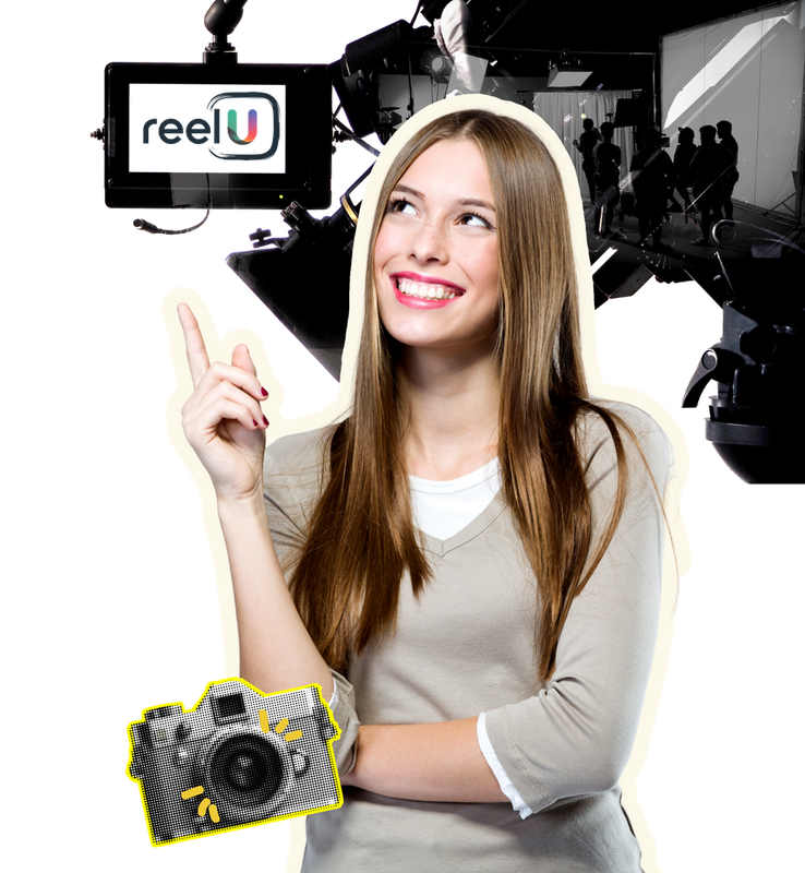 A woman is holding a camera in front of a sign that says reelu